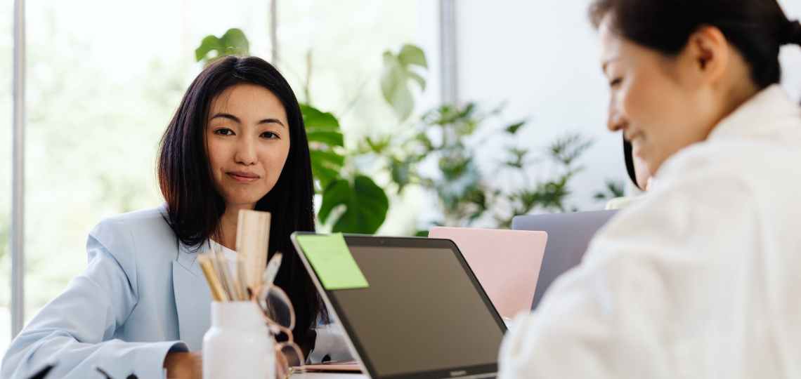 woman in white long sleeves using a laptop