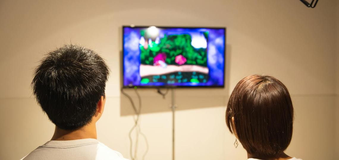 unrecognizable young couple playing video game at home