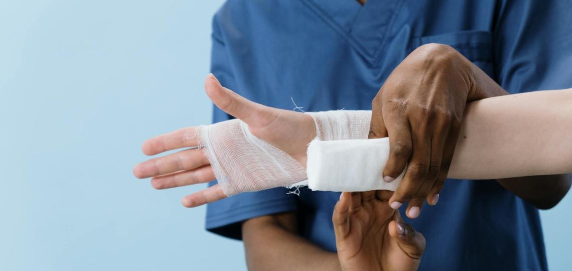 a person getting his hand bandaged