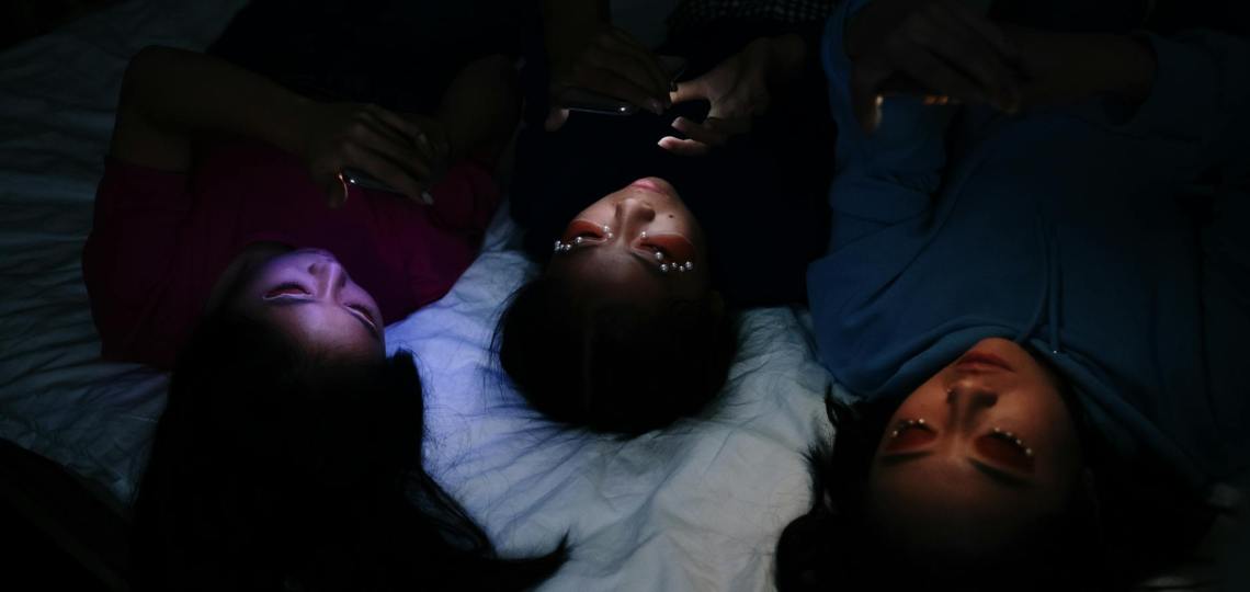 woman in black shirt lying on bed