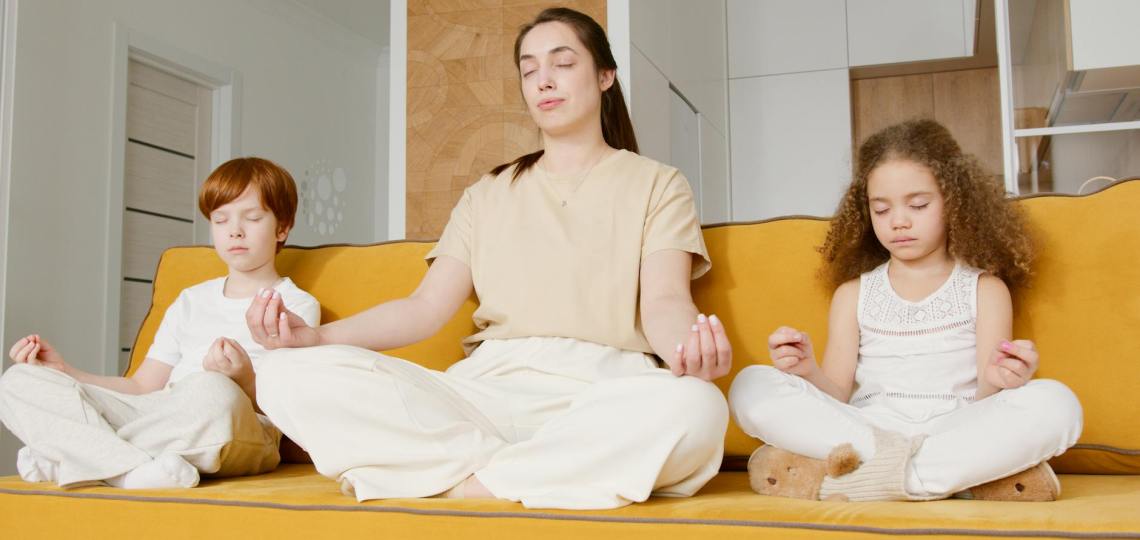 a woman meditating with her children