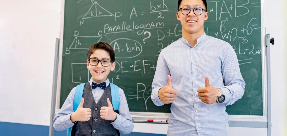 a teacher and a student doing a thumbs up
