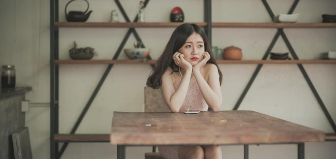 photography of a woman sitting on the chair listening to music